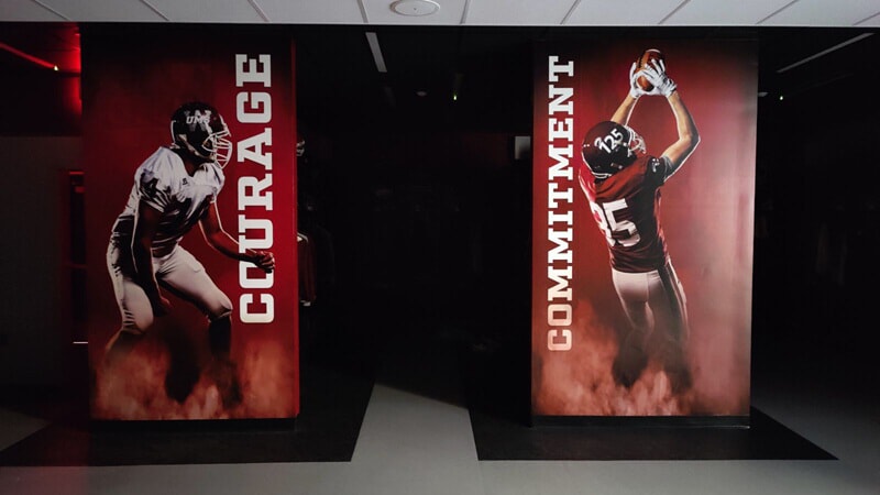 An image of the interior signage in the locker room with words like "Courage" and "Commitment" displayed.